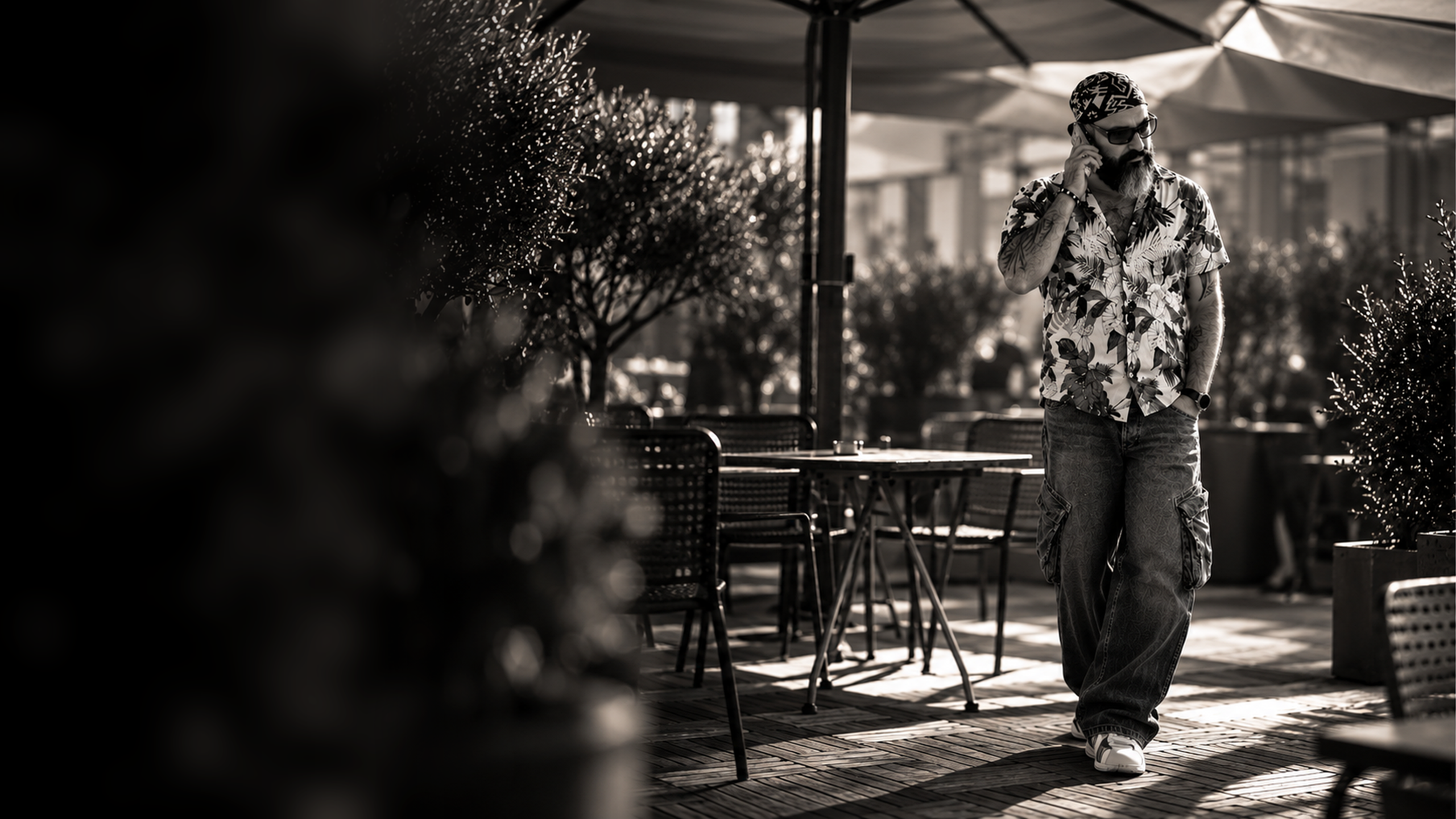 Omid Rahimi walking on a terrace, on the phone